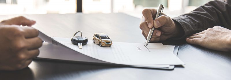 Signing a car purchase agreement
