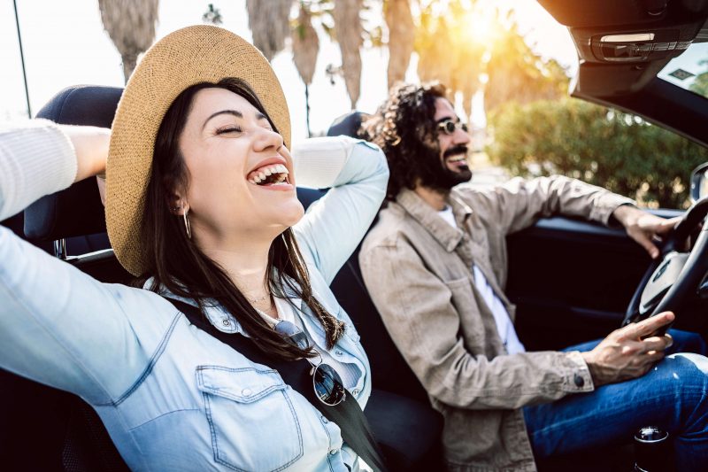 Happy couple driving