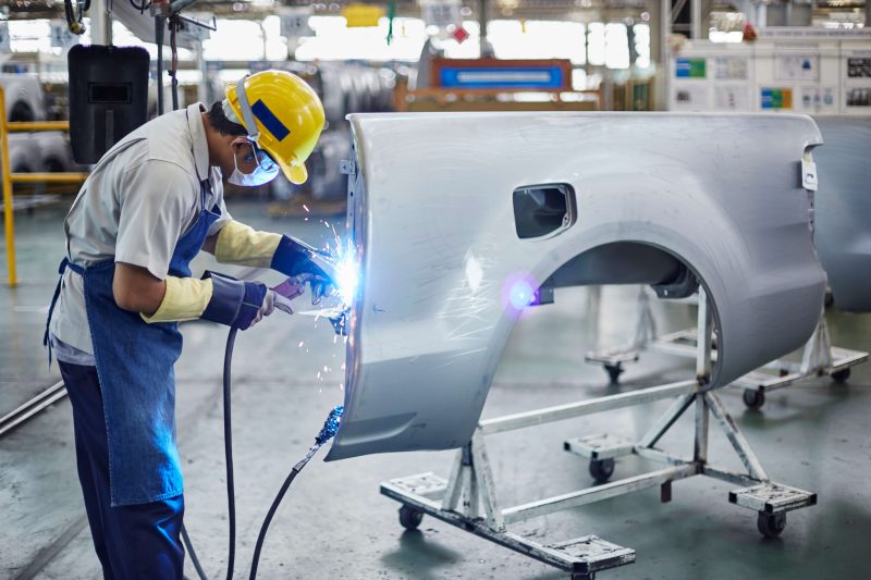 Factory worker building car